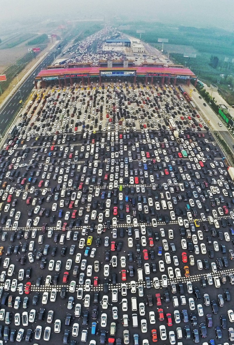 BEIJING, CHINA - OCTOBER 06:  (CHINA OUT) (EDITORS NOTE: Image captured with a fisheye lens) Aerial view of cars queuing up to pass a checkpoint set recently in the direction of Beijing on the Beijing-Hong Kong-Macau Expressway at the end of National Day Holiday on October 6, 2015 in Beijing, China. A travel peak appeared at the end of 7-day China's National Day Holiday.  (Photo by ChinaFotoPress/ChinaFotoPress via Getty Images)